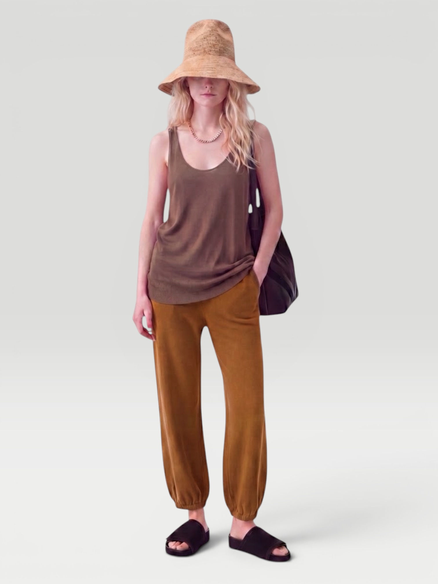 Suzie Kondi Kalamata Cashmere Pant in brown, worn with Suzie Kondi Kismet Cashmere Sweater, Phoebe Philo Pot Cabas Suede and Leather Tote Bag, Phoebe Philo Suede Slides, Spinelli Kilcollin Gravity Chain Necklace. Styled by Sharon Lombardo for FDV Concierge.