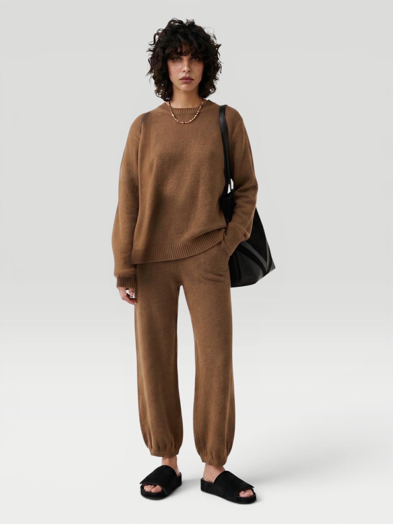 Suzie Kondi Kismet Cashmere Sweater in brown, worn with Suzie Kondi Kalamata Cashmere Pant, Phoebe Philo Pot Cabas Suede and Leather Tote Bag, Phoebe Philo Suede Slides, Spinelli Kilcollin Gravity Chain Necklace. Styled by Sharon Lombardo for FDV Concierge.