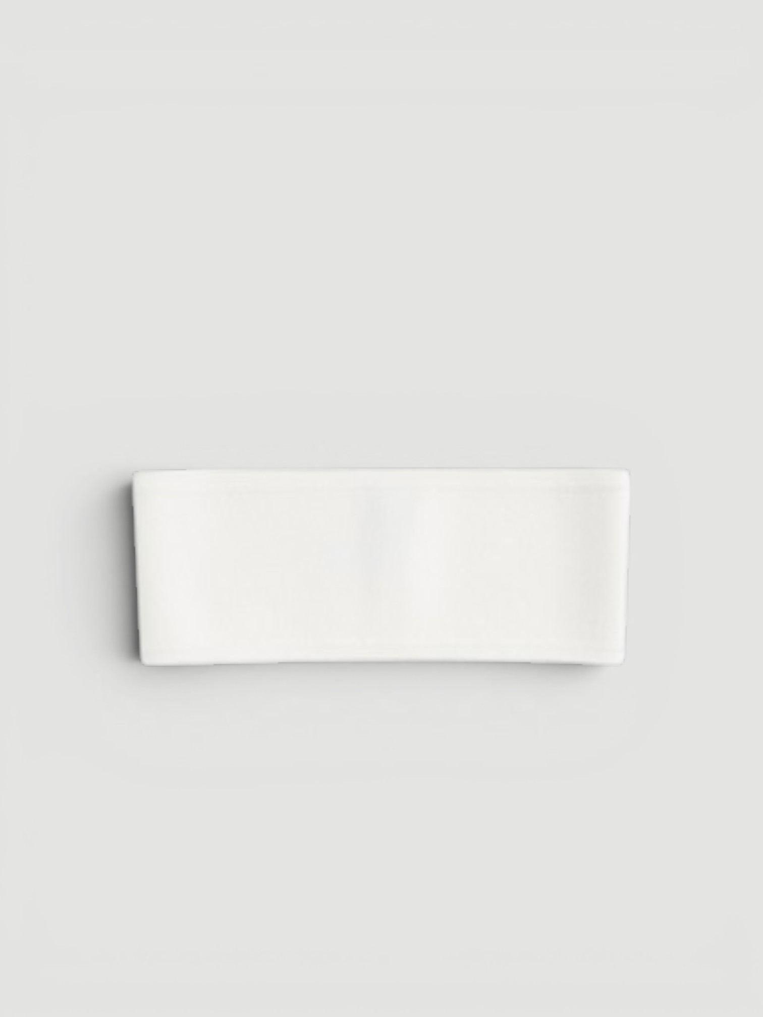 Toteme Compact Knit Headband in white.