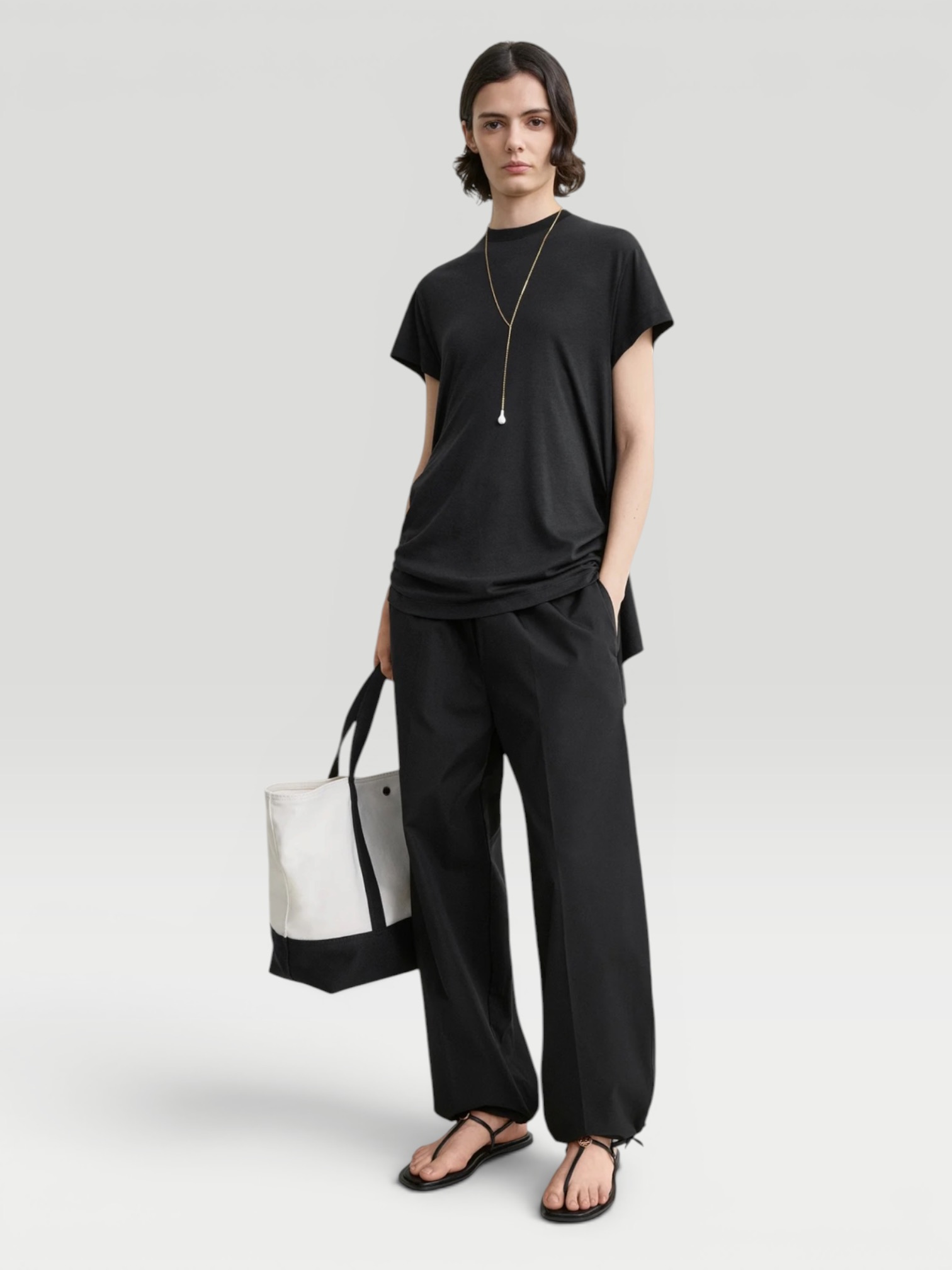 Totême Drawstring Cotton Trousers in black. Styled by Sharon Lombardo for FDV Concierge.