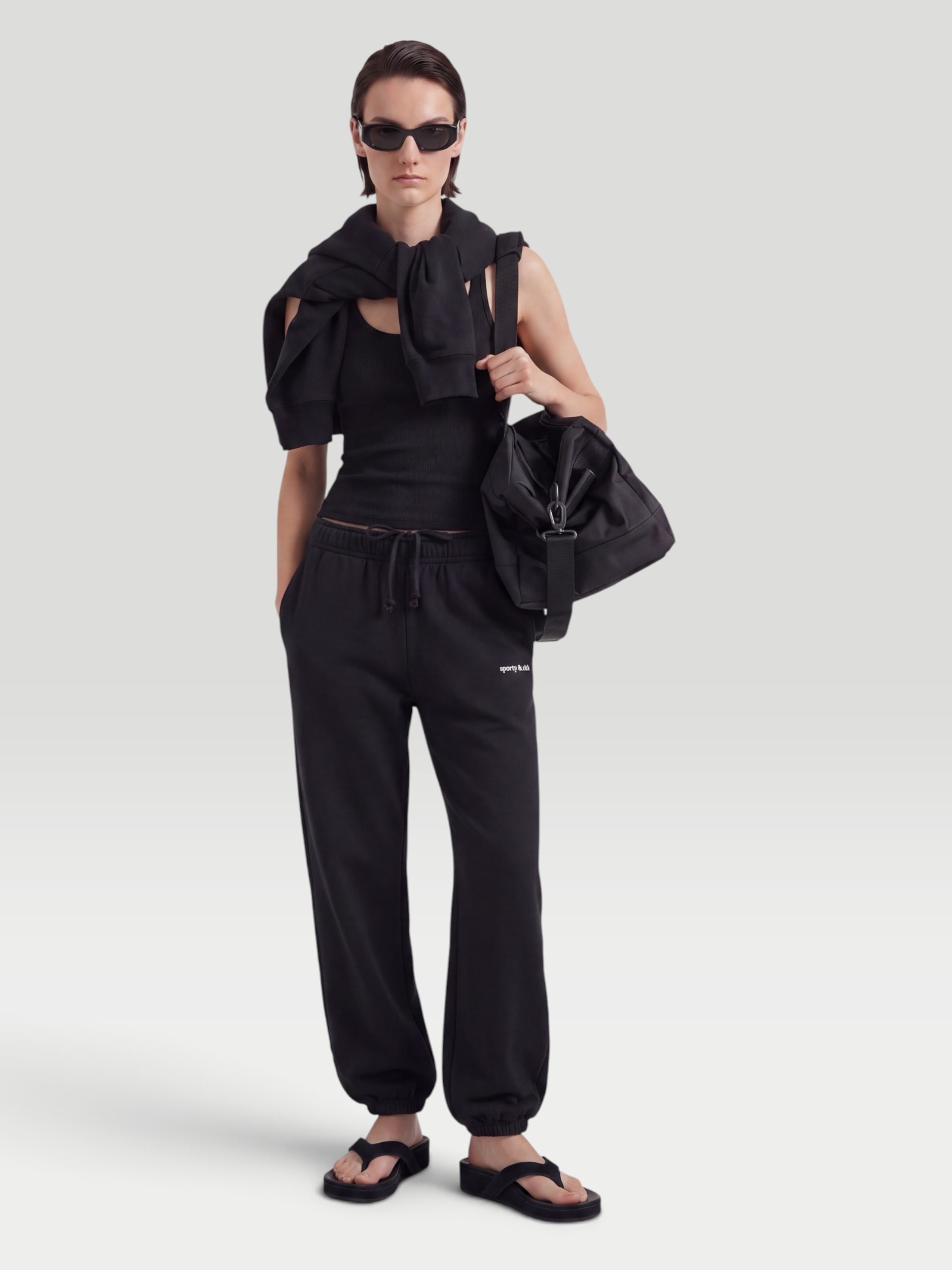 Venroy Fleece Track Pant in black, worn with St. Agni Soft Jersey Slim Scoop Tank, Kallmeyer Yasmin Tunic in Novelty Cotton Slub, Phoebe Philo Frizz Flip Flop, Leatherology Barrel Gym Bag, the journey. Styled by Sharon Lombardo for FDV Concierge.
