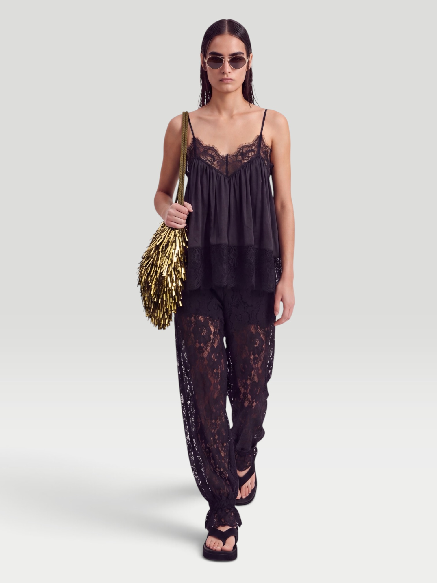 WeWoreWhat Balloon Lace Trouser in black, worn with WeWoreWhat Lace Voile Cami Top, Phoebe Philo Frizz Flip Flop, Liffner Tassel Satin Shoulder Bag, Bottega Veneta Cat-Eye Acetate Sunglasses, the evening. Styled by Sharon Lombardo for FDV Concierge.