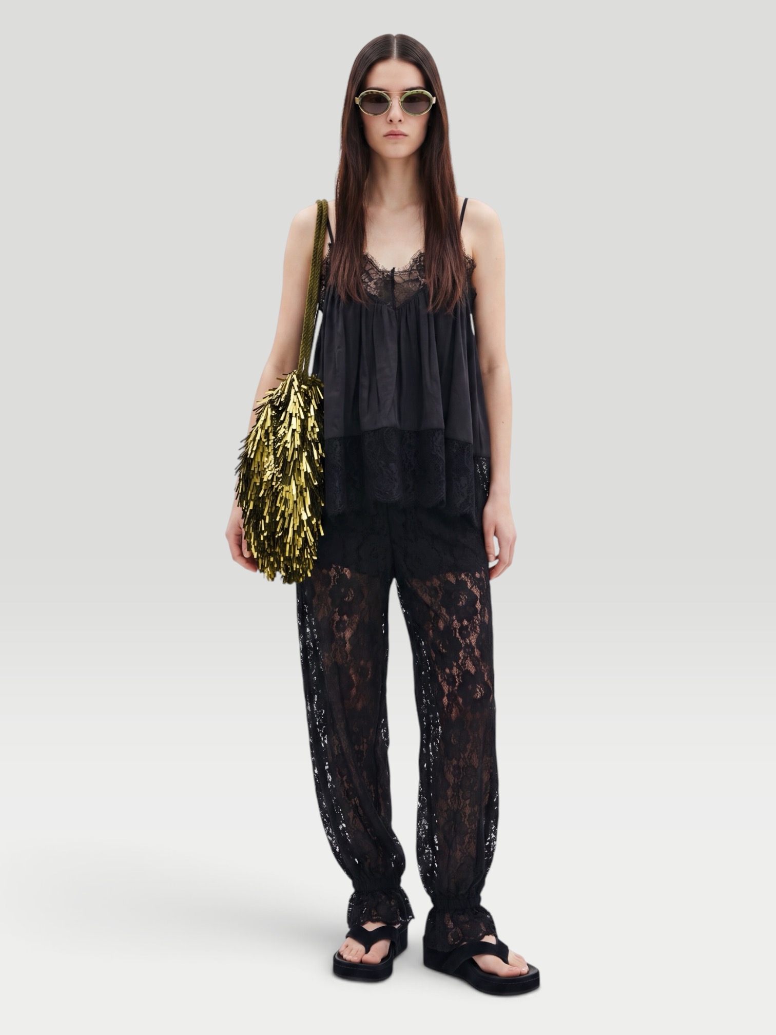 WeWoreWhat Lace Voile Cami Top in black, worn with WeWoreWhat Balloon Lace Trouser, Phoebe Philo Frizz Flip Flop, Liffner Tassel Satin Shoulder Bag, Bottega Veneta Cat-Eye Acetate Sunglasses, the evening. Styled by Sharon Lombardo for FDV Concierge.