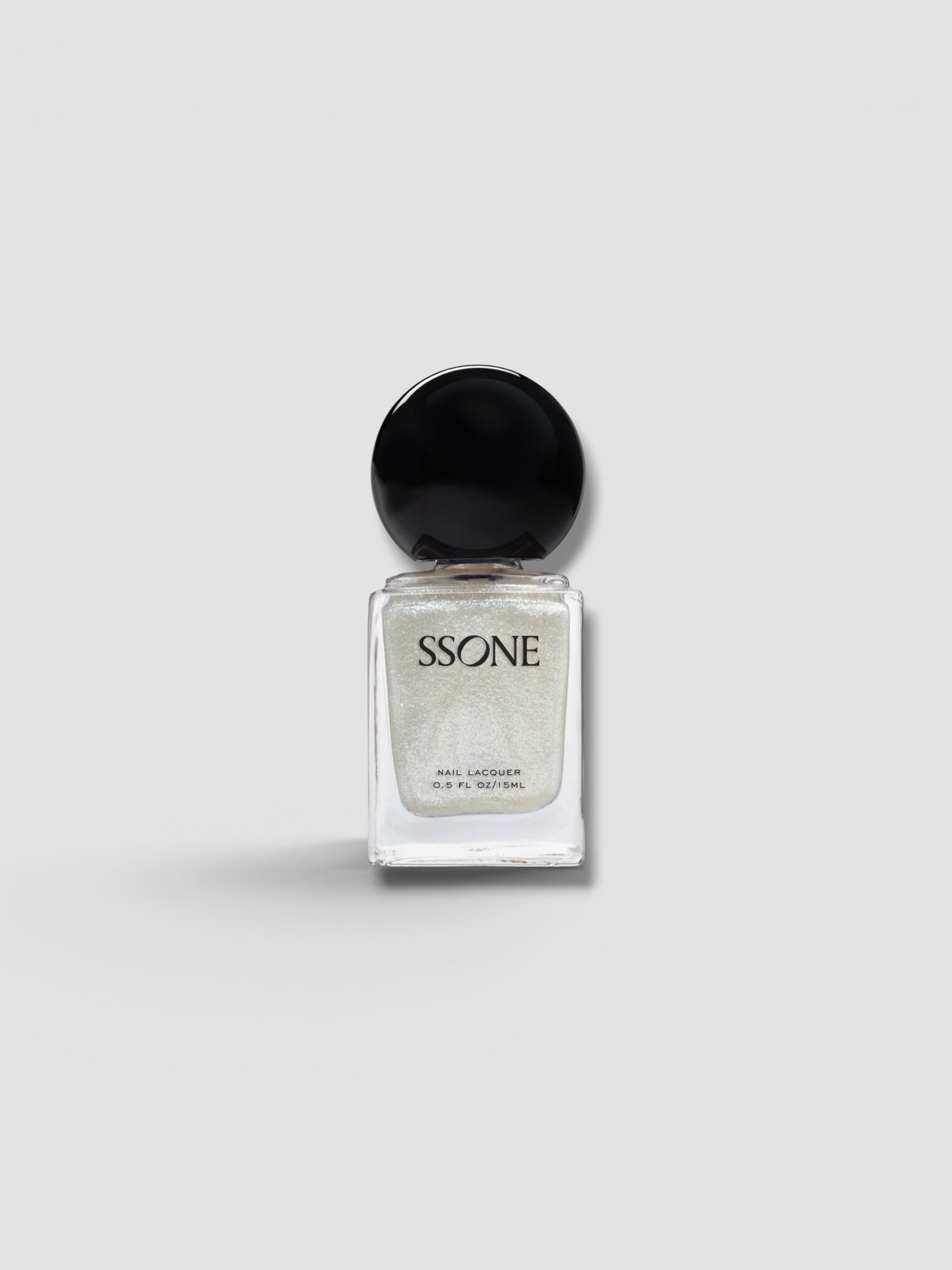 SSONE Exclusive La Isla Nail Lacquer in last glimmer, worn with Marrakshi Life The Palazzo Striped Cotton Wide-Leg Pants, Bottega Veneta Sampieri Flat Thong, walking the city. Styled by Sharon Lombardo for FDV Concierge.